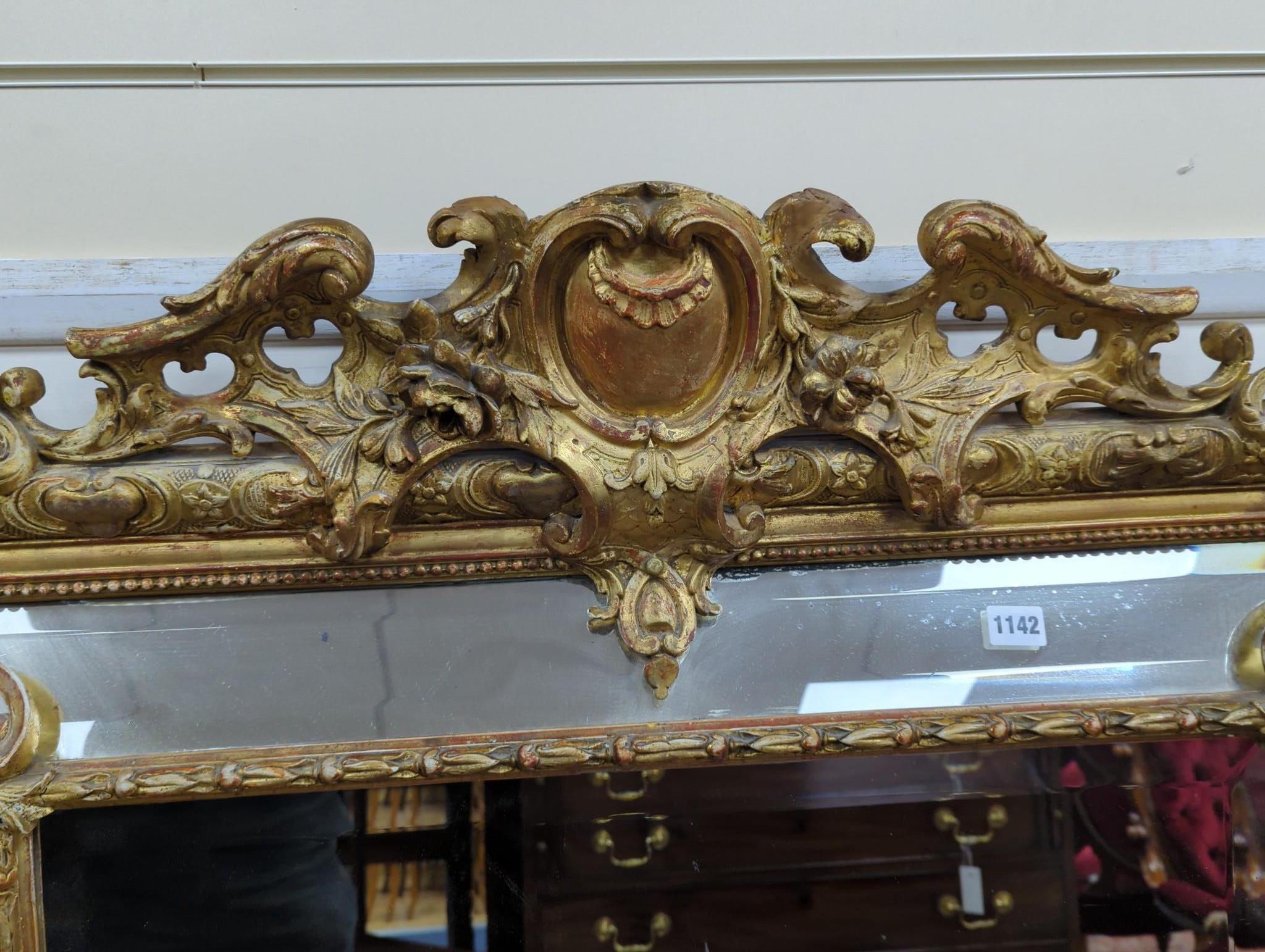 A large 19th century French gilt and gesso frame, bevel edged mirror with cushion margin, plated and C scroll, width 108cm, height 137cm
